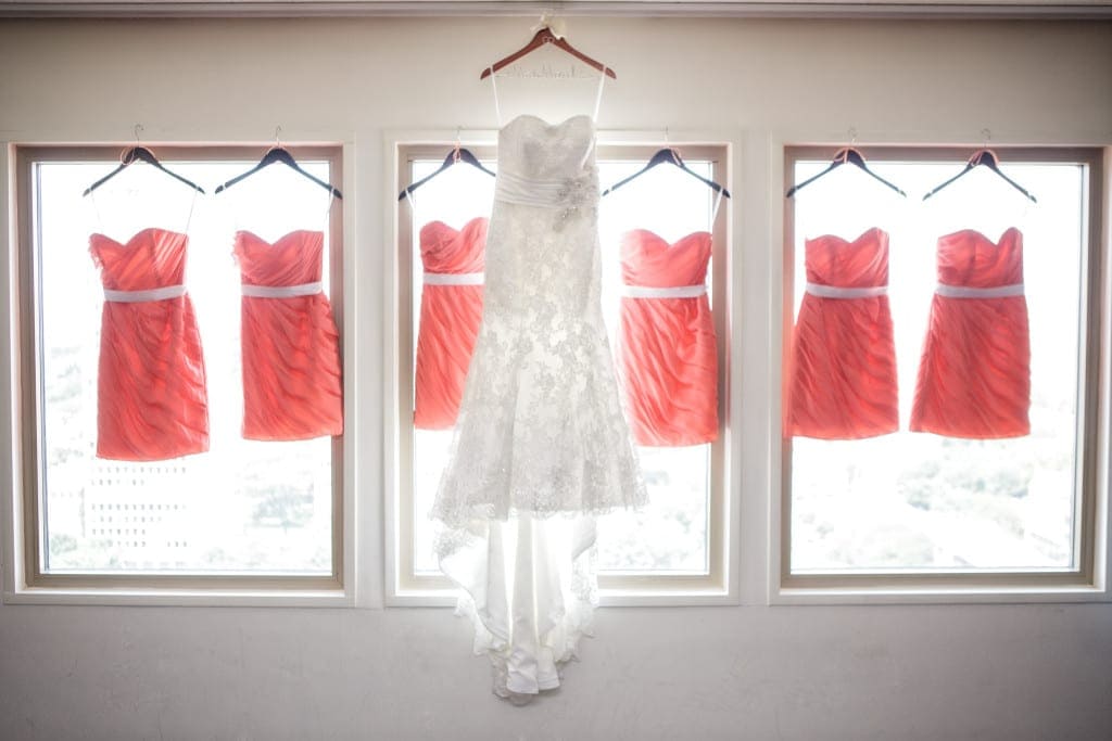 Lace Wedding dress displayed in the window with summery coral bridesmaids dresses.