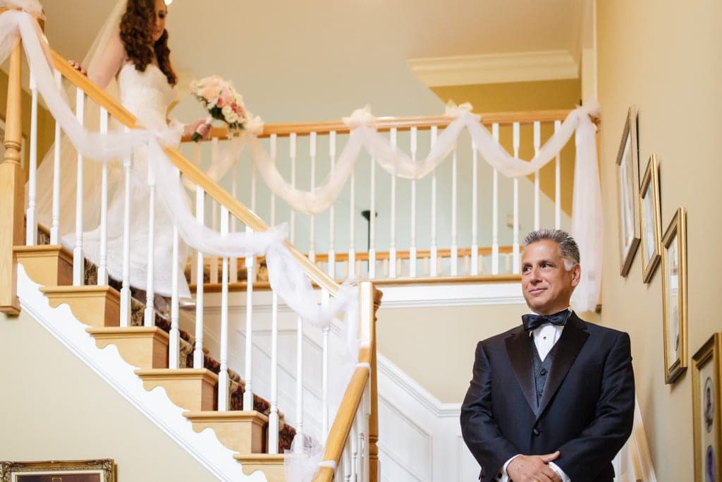 The white tulle on the banisters added a lovely wedding day touch to Diana's parent's house as she came down the stairs for a father daughter first look. 