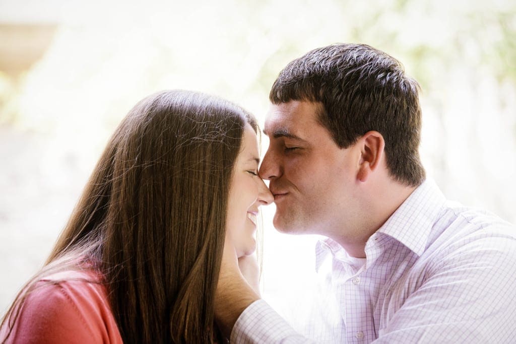 Pulling your fiancé in for a soft kiss is a romantic and dramatic pose without feeling over the top.