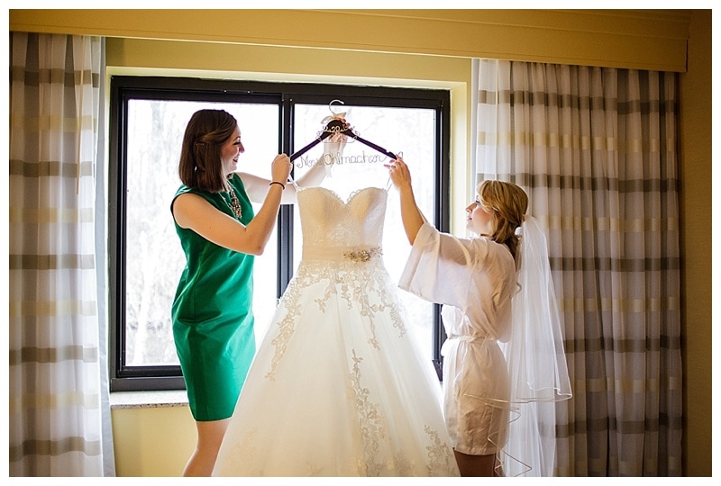 With a little help from a tall maid of honor, Charmaine gently removed her dress from where it hung. 