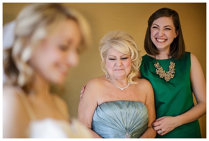 What a proud mama looking at her beautiful daughter as she dresses for one of the best days of her life.