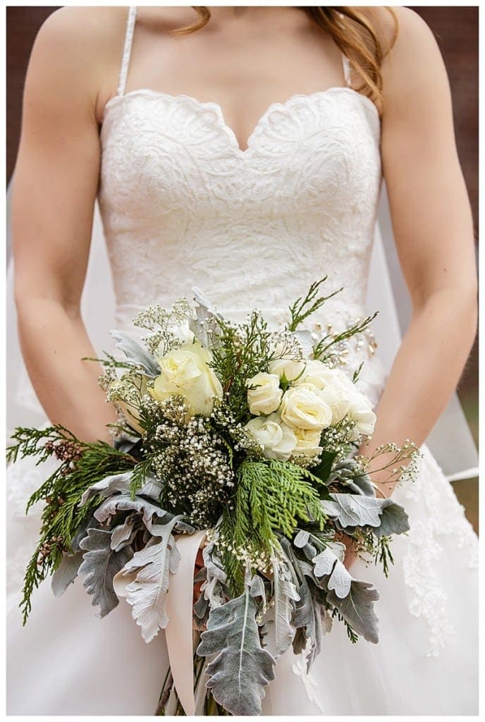 Charmaine's beautifully textured bouquet held in front of her perfectly tailored gown as she again proved her toughness as she braved the cold air to show off her dress. 
