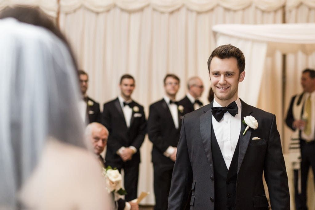 Nate greeting his bride in the aisle.