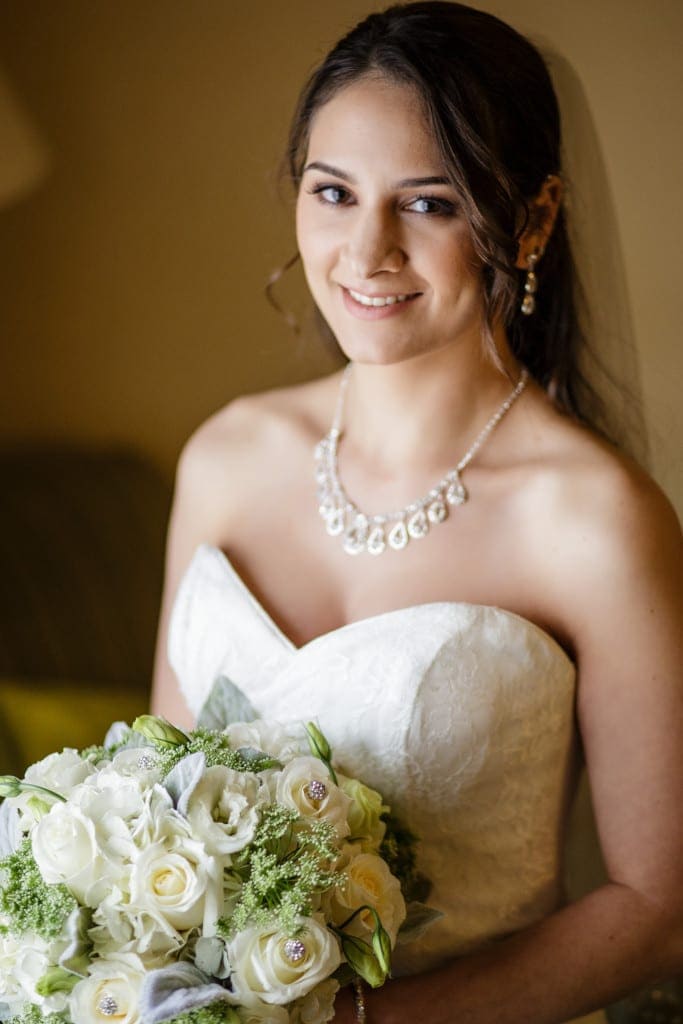 Gorgeous window light made for a beautiful portrait of Michelle as she waited to walk the aisle to Chris.