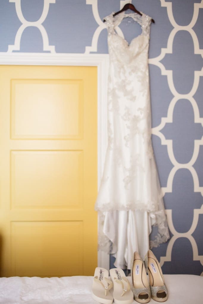 The brides lovely dress hanging in the bright and colorful Hotel Monaco.