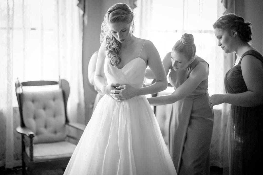Catherine being zipped into her beautiful Anne Barge gown.