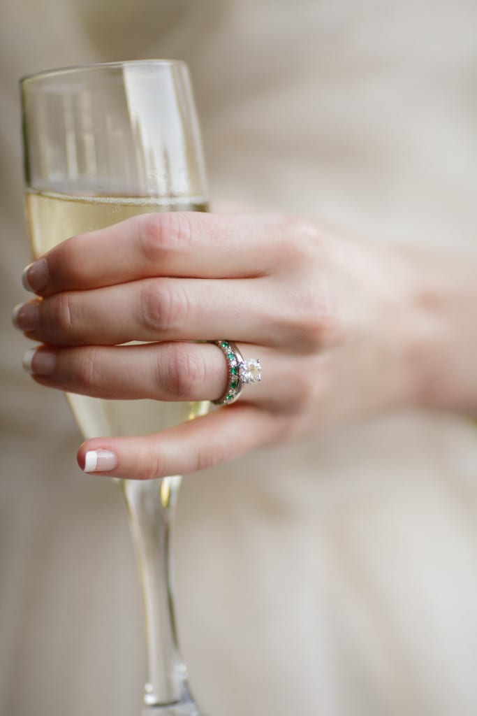 A celebratory glass of champagne while showing off the new wedding band. 