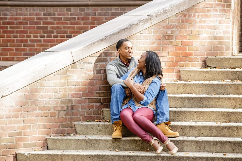 engagement pictures of young couple on steps at Rutgers campus