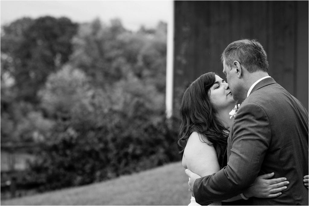 black and white portrait of bride and groom at a rustic wedding barn in PA