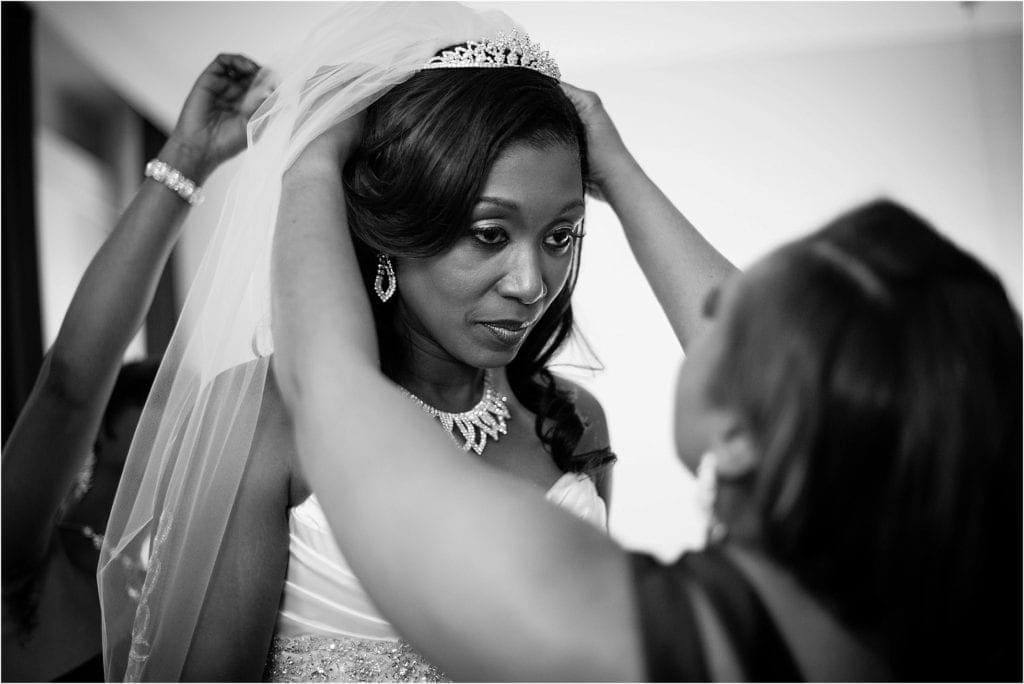 bride putting on veil before ceremony- photos by Ashley Gerrity Photography