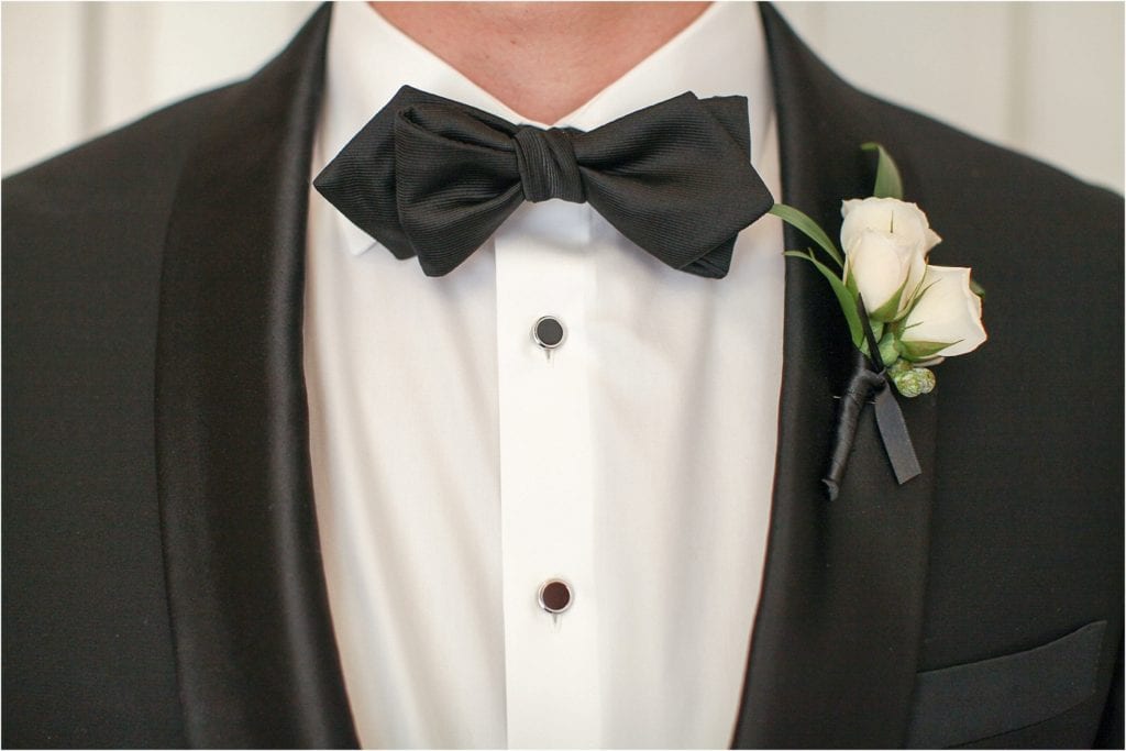 Elegant Cescaphe Downtown Club Wedding - tuxe and black bowtie white flowers