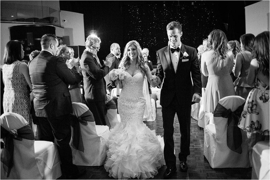 unique exit photo of bride and groom after wedding ceremony - black and white pictures