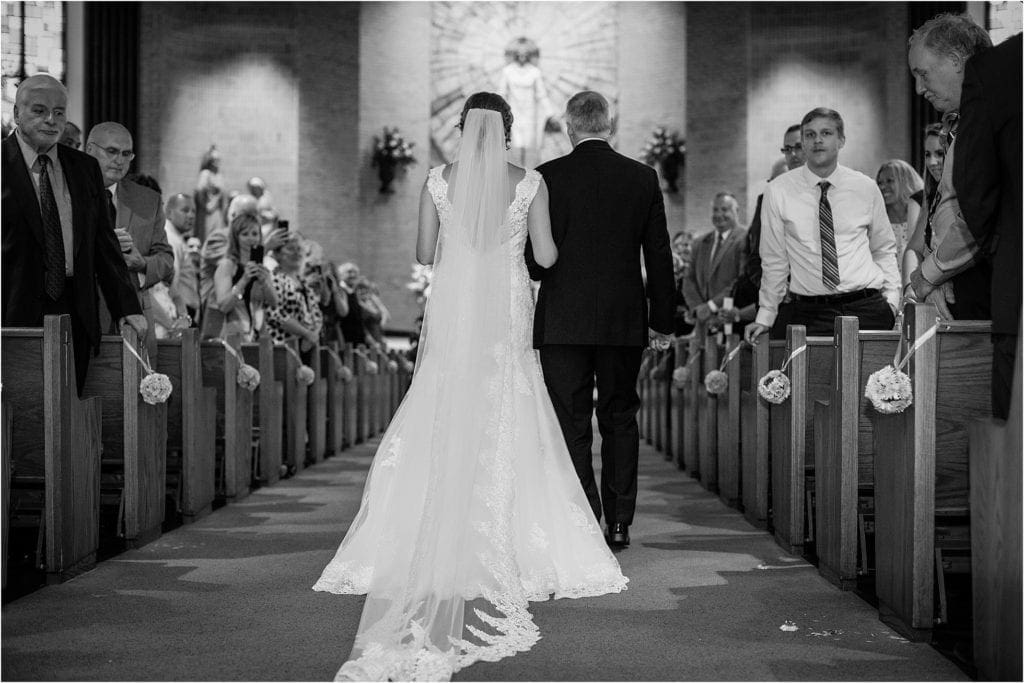 gorgeous photo of bride walking in church for her wedding in Central PA