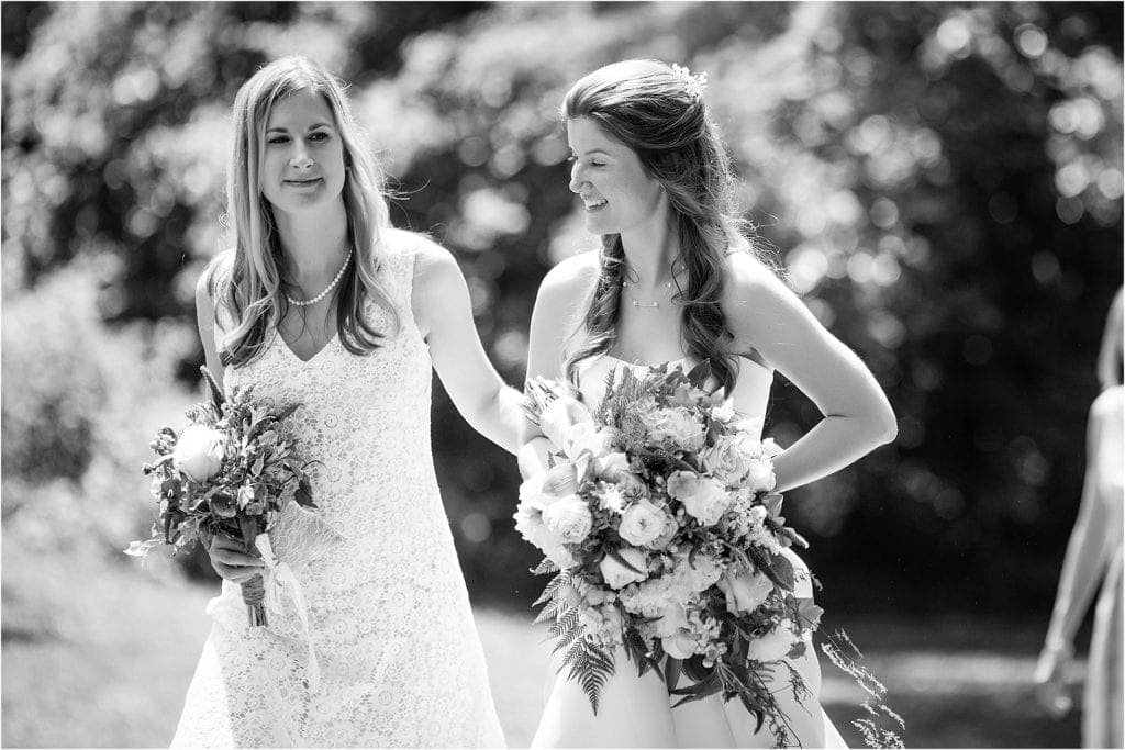 bride entering wedding ceremony with mom during her outdoor wedding in Philly