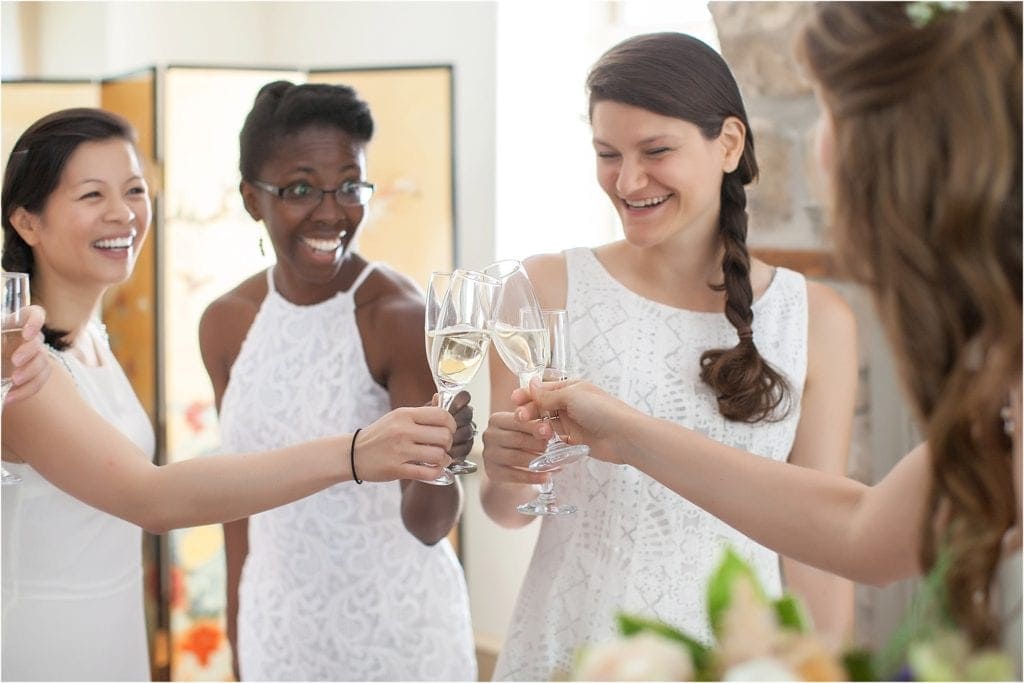 toast during getting ready, bridesmaids wearing white, 