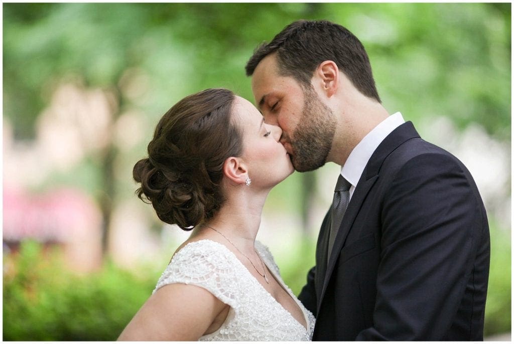 the perfect kiss photo of bride and groom outdoors