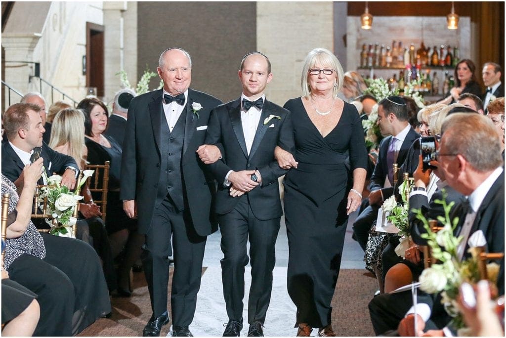 Groom walking down Jewish wedding ceremony with parents- Union Trust venue 