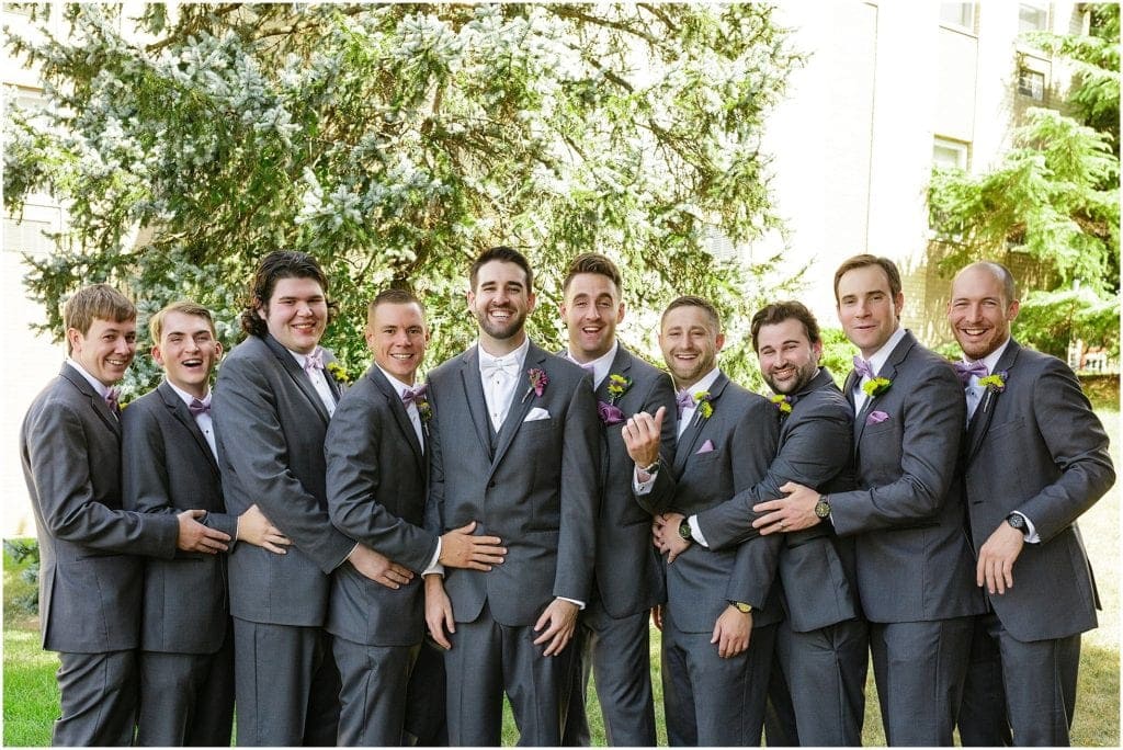 dark gray suites with lavender bow ties for grooms men
