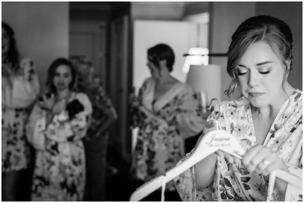 One of our favorite moments during bridal prep is the last time that the bride holds her wedding dress before putting it on.
