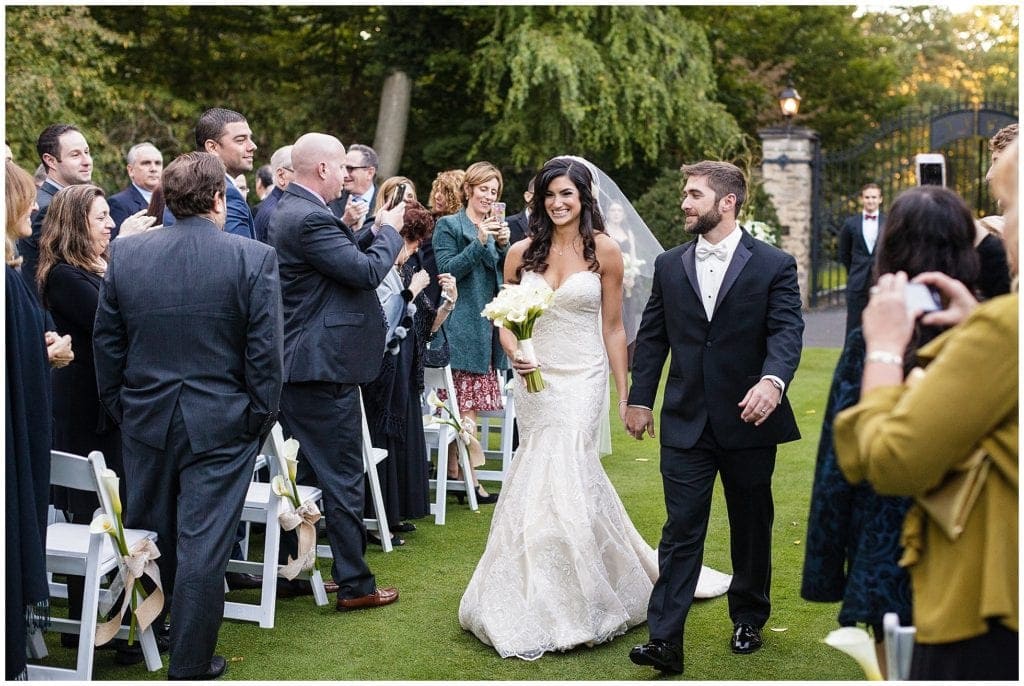 photos of gorgeous bride walking out outdoor ceremony at Huntingdon Valley Country Club 