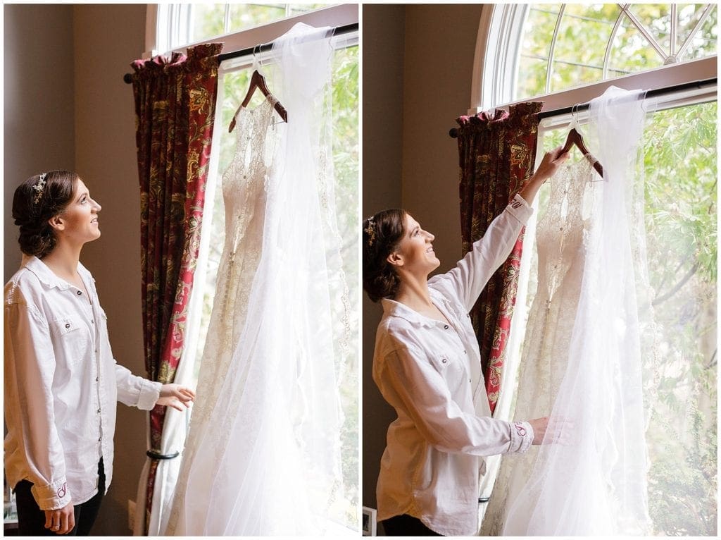 Photo of bride grabbing her DaVinci Bridal weddings dress during getting ready photos