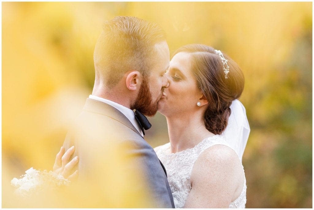 Bride and groom kissing for their fall wedding. Photos by Ashley Gerrity Photography