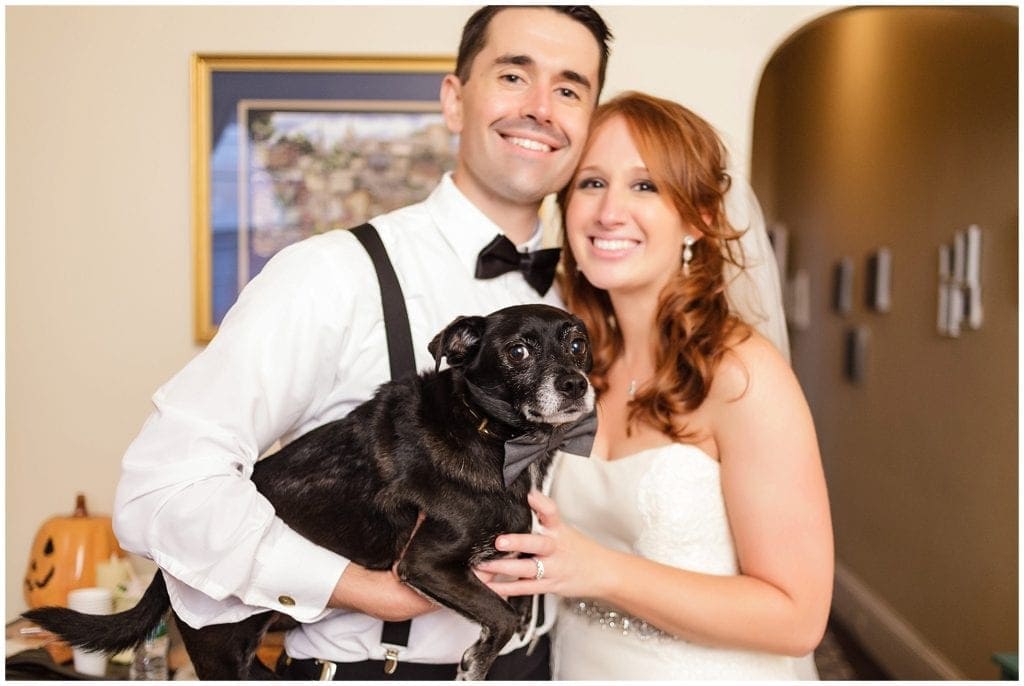 Bride and groom stop by their house to take portrait with their lovely dog 