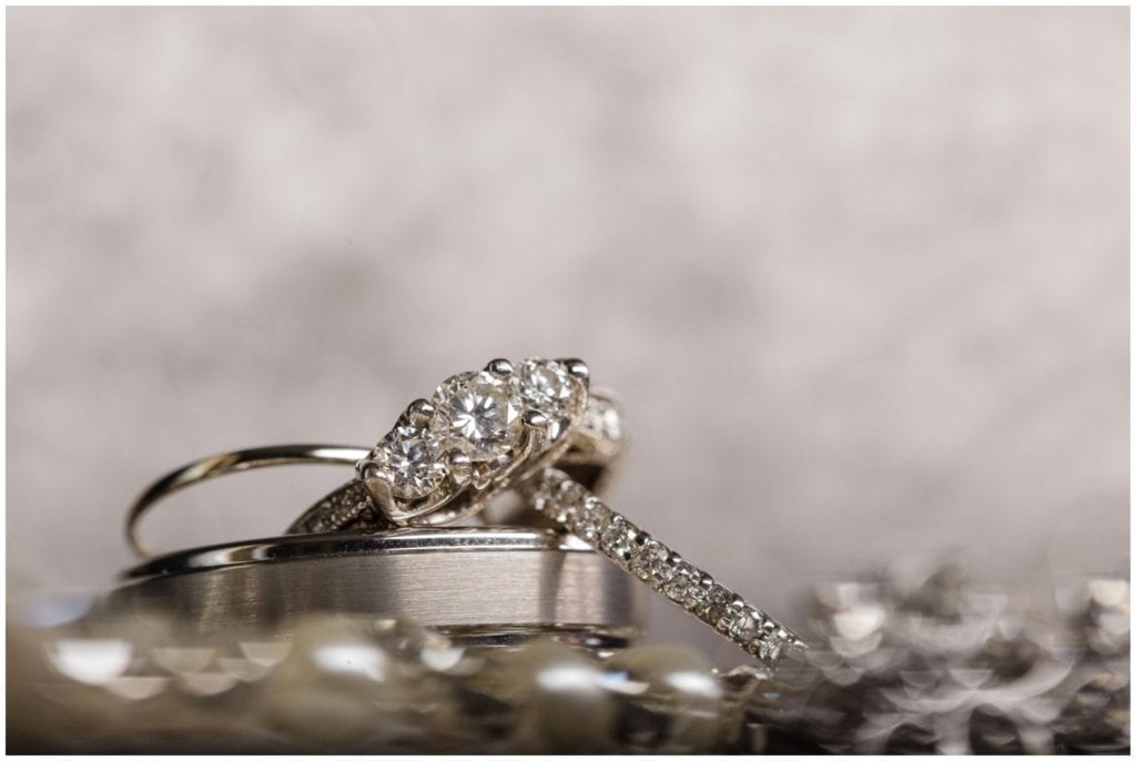 platinum three stone diamond engagement ring with pave diamond wedding bands