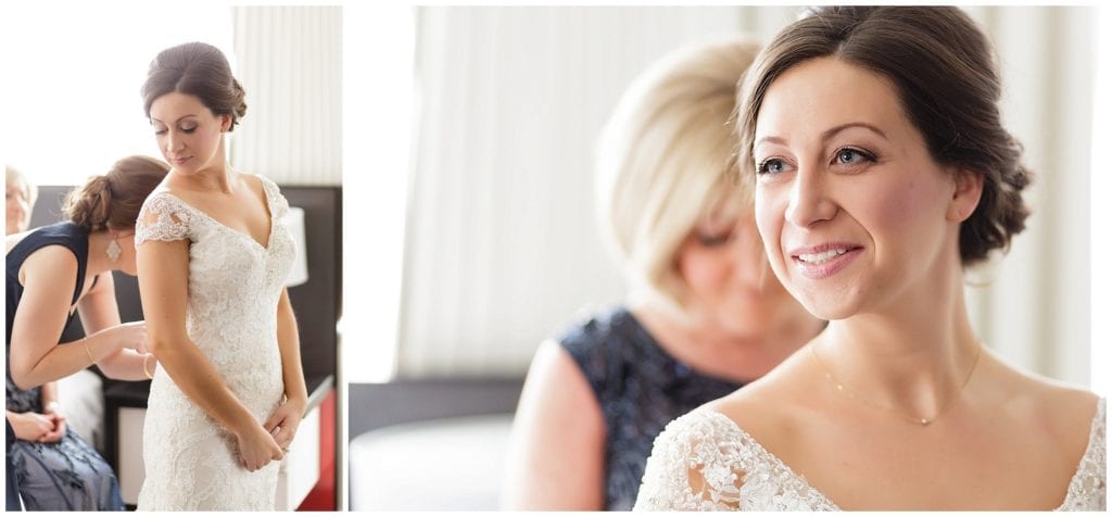 Classic bridal hair and bride putting on dress at Loews Philadelphia Hotel