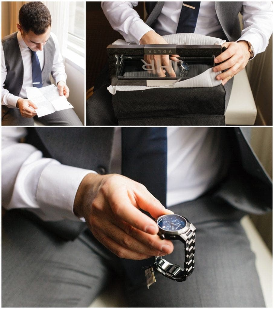 groom opening his wedding day gift at Loews Philadelphia Hotel