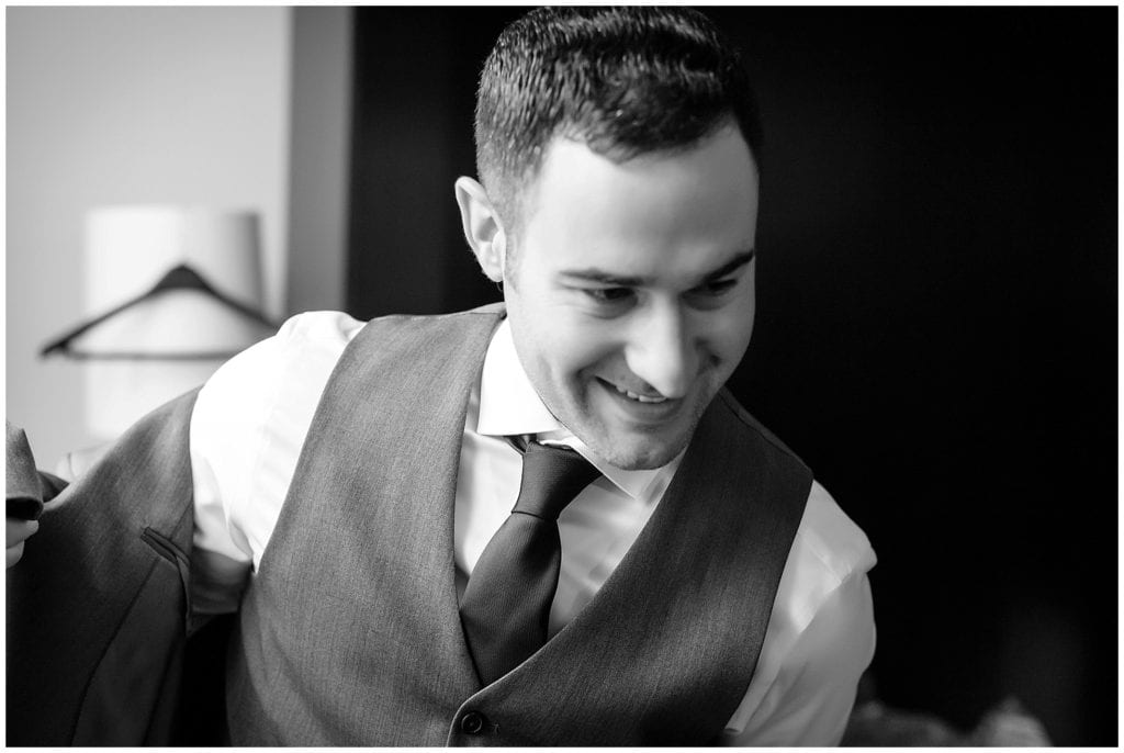 black and white photo of groom getting ready at Loews Philadelphia Hotel