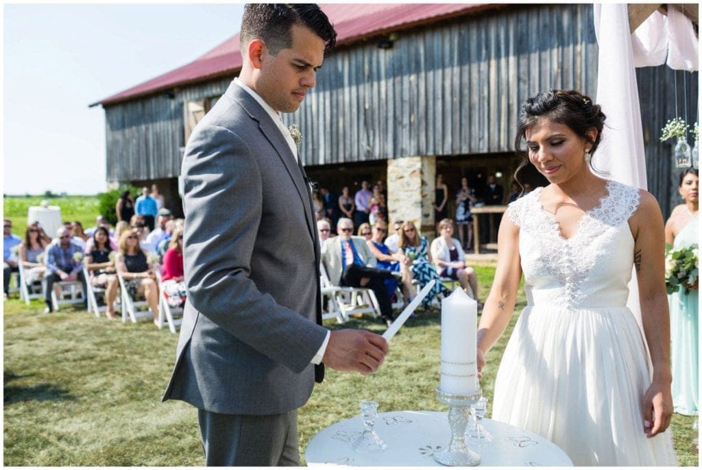 Candle lighting by bride and groom at their Historic Penn Farm wedding.