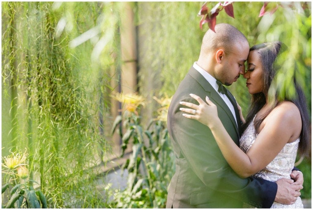 Shooting through the greenery during a Longwood Gardens engagement session can create a sense of intimacy in the pose and visual interest in the portrait.