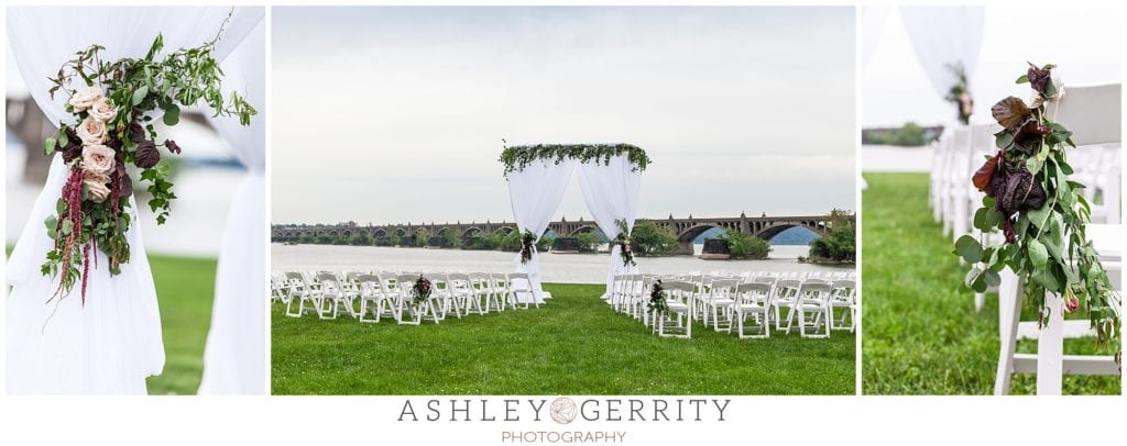 Outdoor wedding ceremony along Susquehanna River at John Wright Restaurant in Wrightsville, PA featuring design by Shumaker PDT