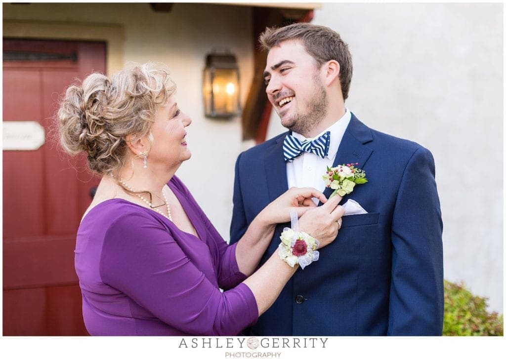 groom, mother of the groom, boutonniere, navy blue suit