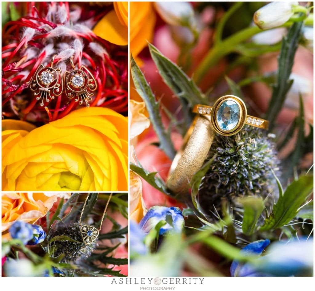blue center stone engagement ring on colorful ranunculi and thistle