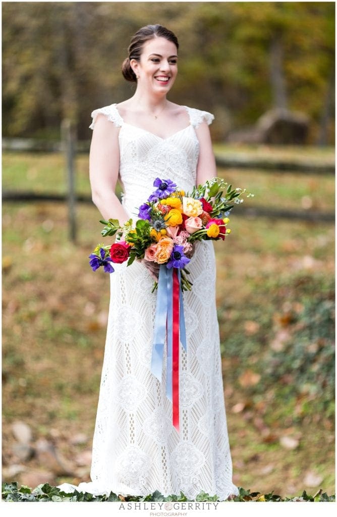 bride with colorful bouquet, Claire pettibone dress, Nicole bridal, outside at Sage Farmhouse