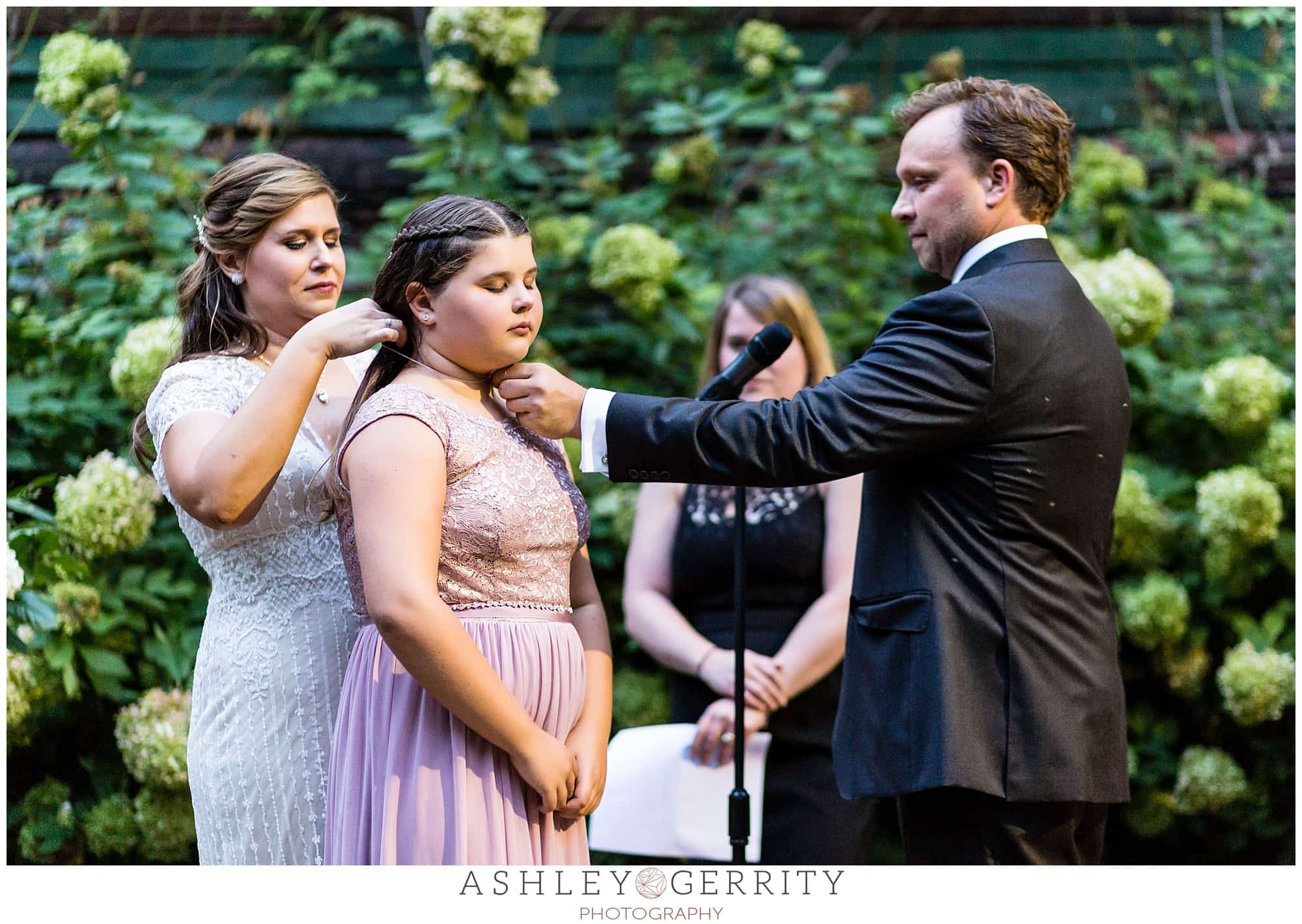 Groom gifts the bride's daughter a Tiffany necklace during their Colonial Dames wedding ceremony as he made vows to her, as well.