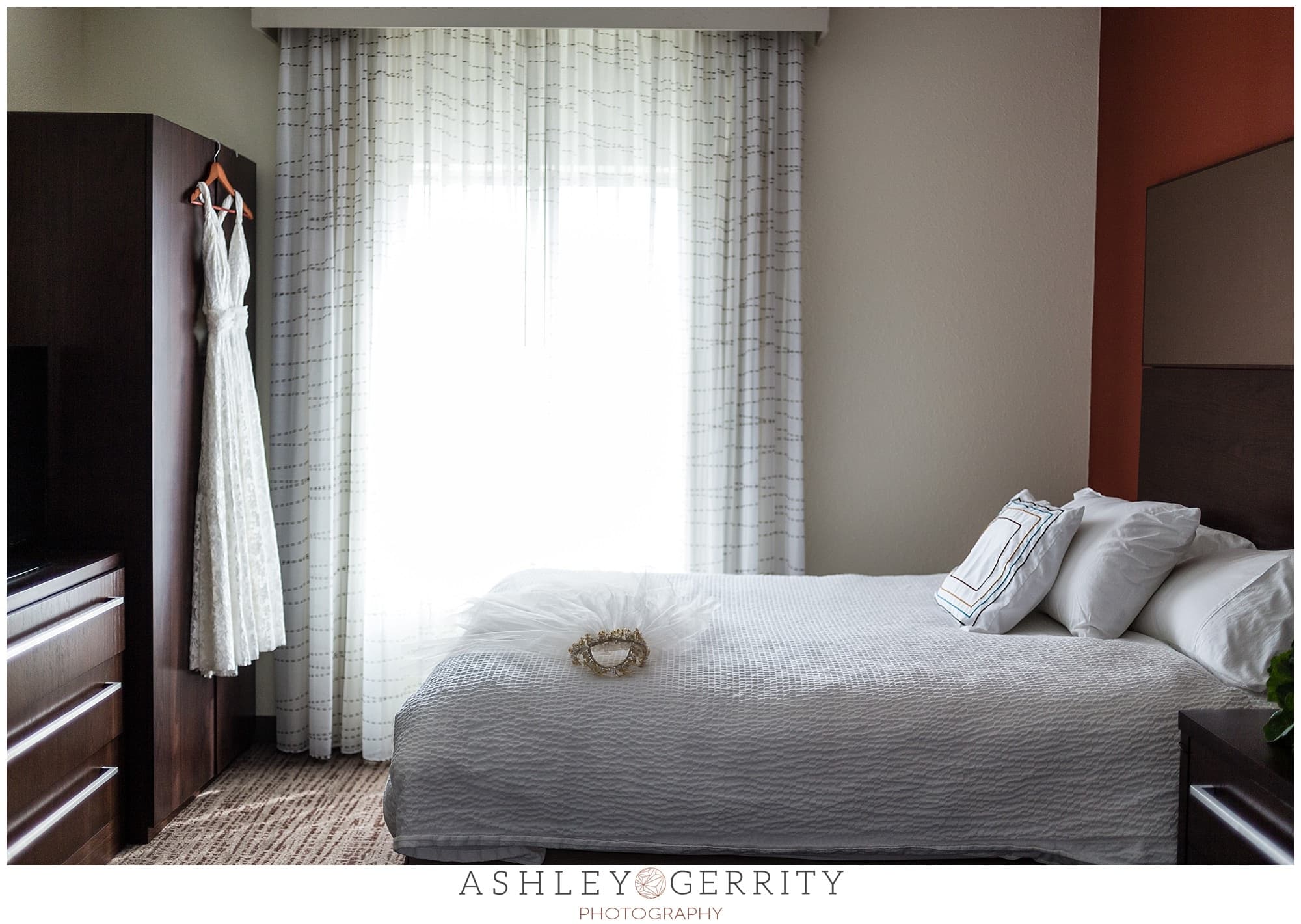 Serene bridal suite with BHLDN wedding gown hanging by the window.