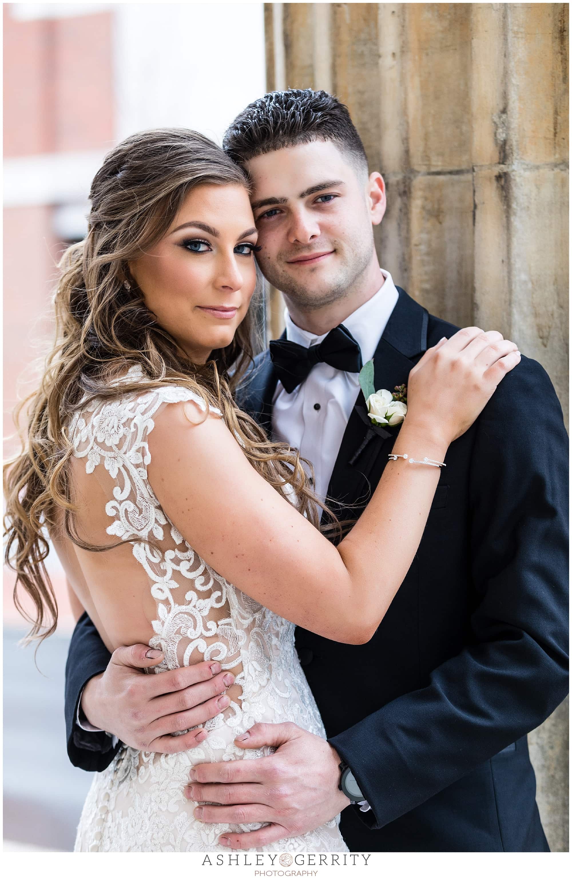 wedding portrait bride and groom portrait holding and hugging back of dress detail