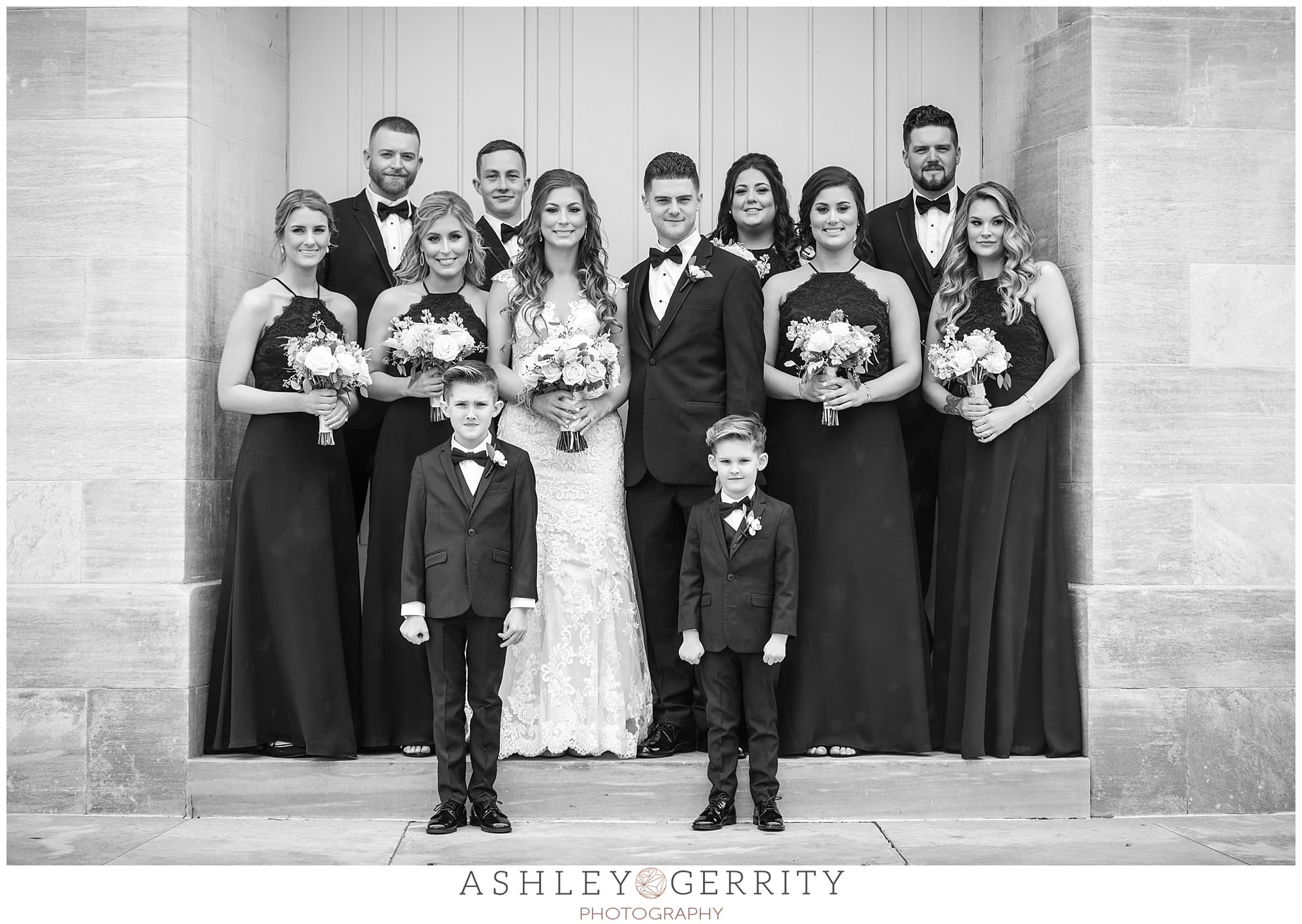 black and white wedding party portrait outside merchant exchange building 
