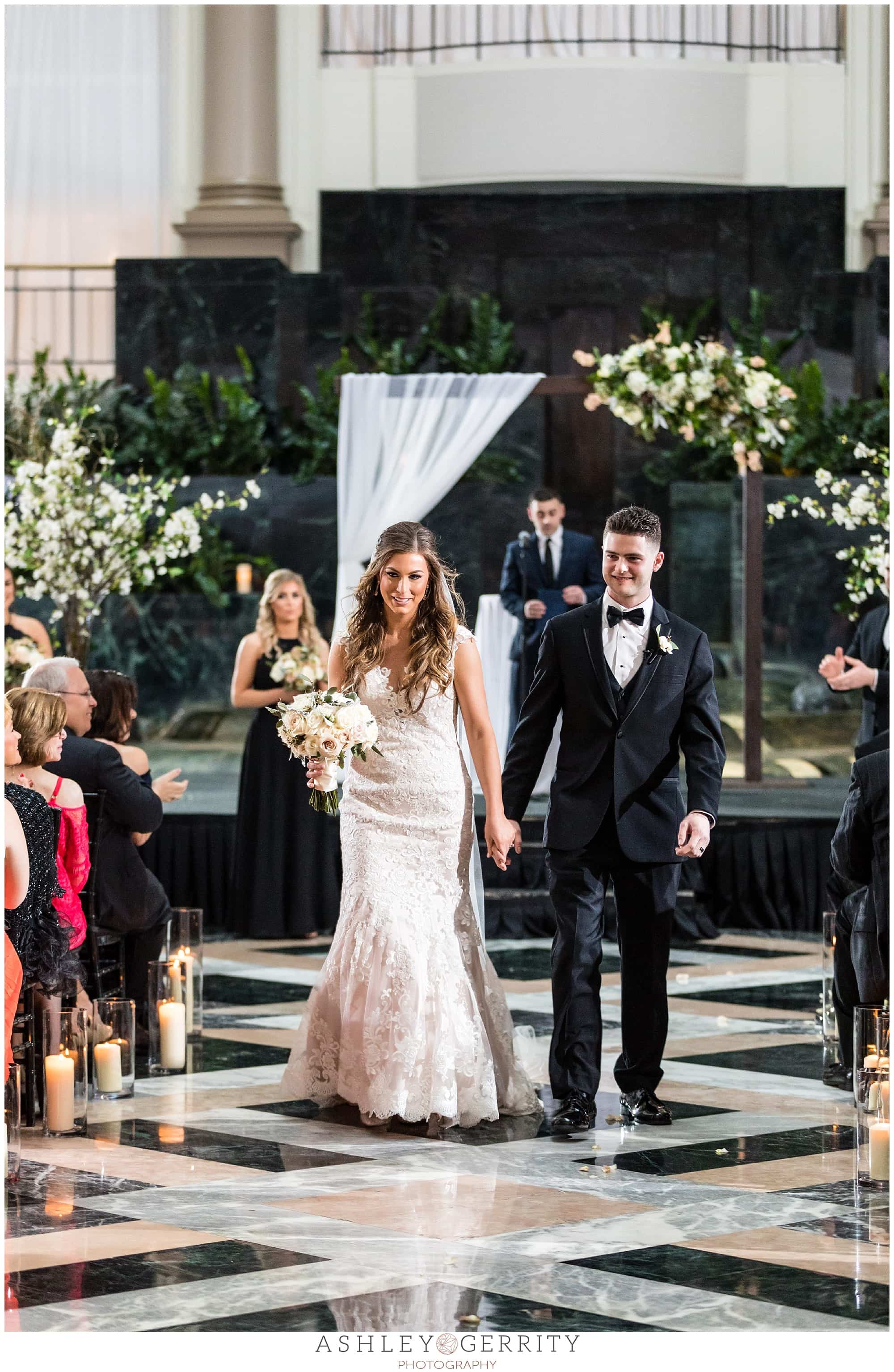 bride and groom walking down the aisle as husband and wife merchant exchange building