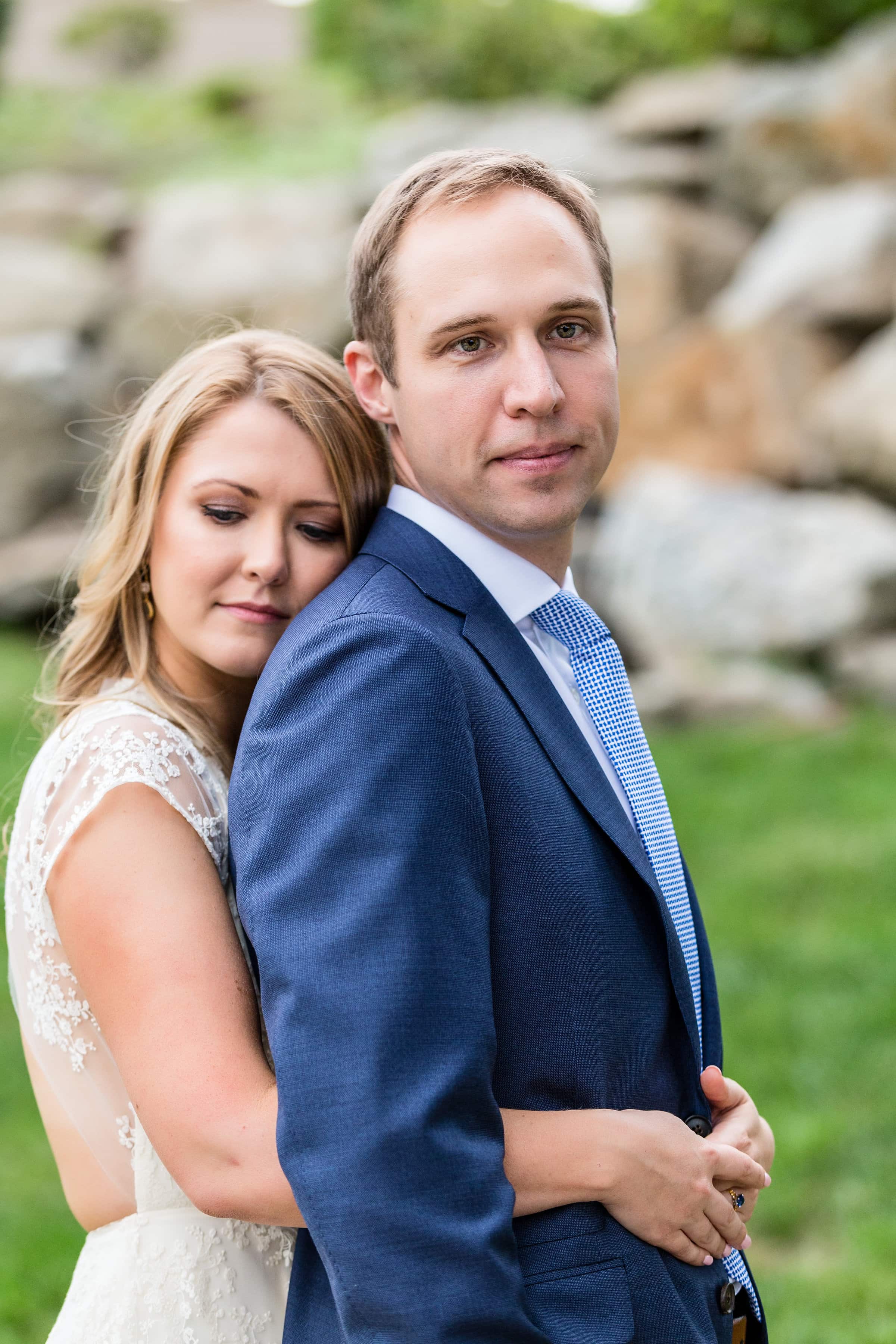 Intimate couple engagement portraits, hugging from behind