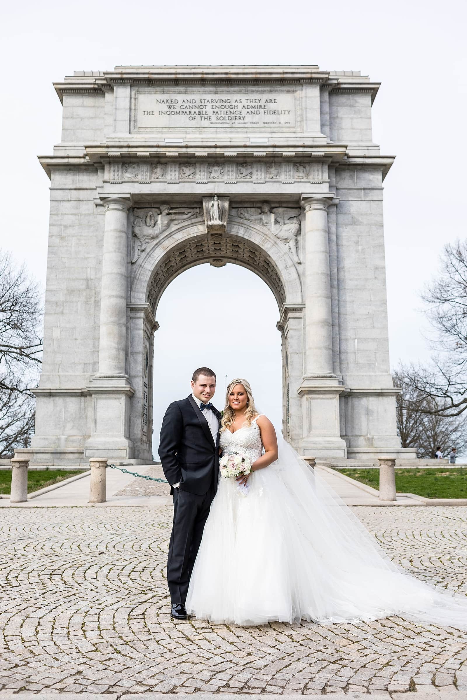Bride & Groom wedding portraits at the memorial arch in Valley Forge National Park.