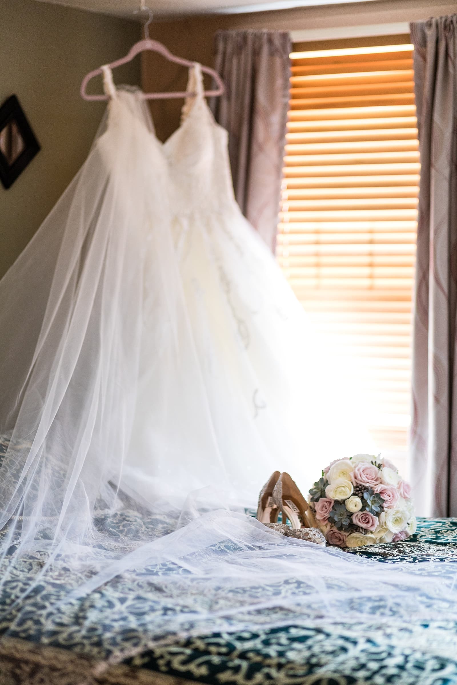 Hanging Martina Liana wedding gown in a bride's childhood bedroom.