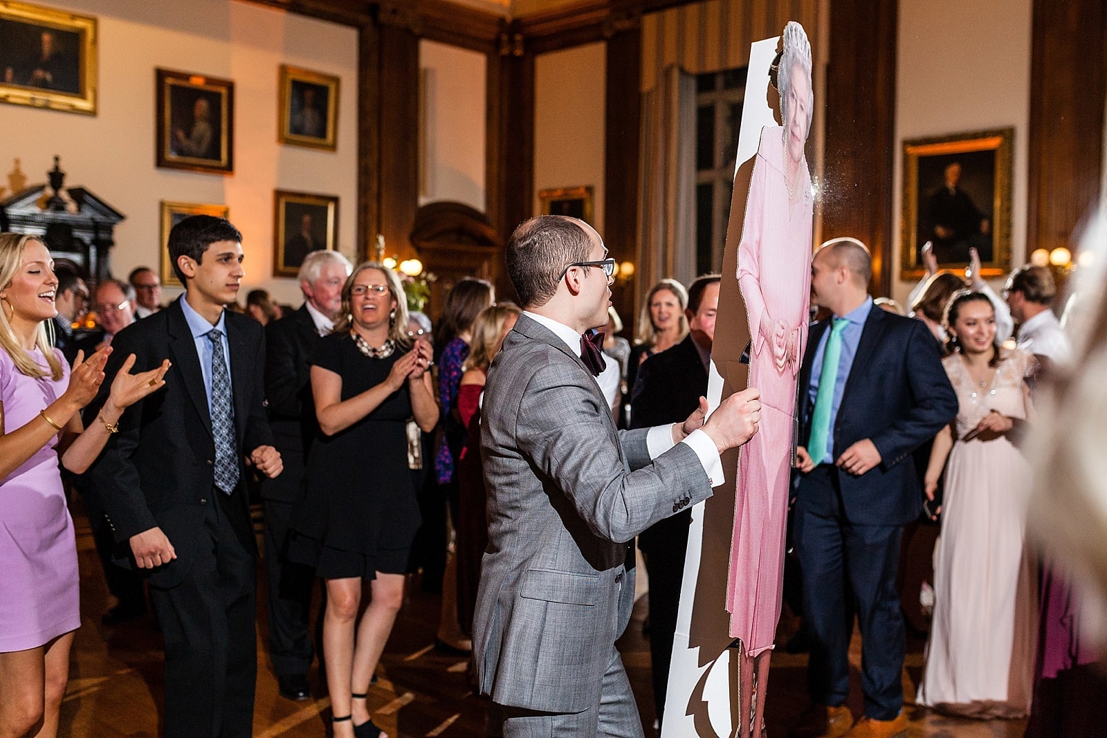 Groom dancing with cardboard cutout of the Queen of England, College of Physicians wedding