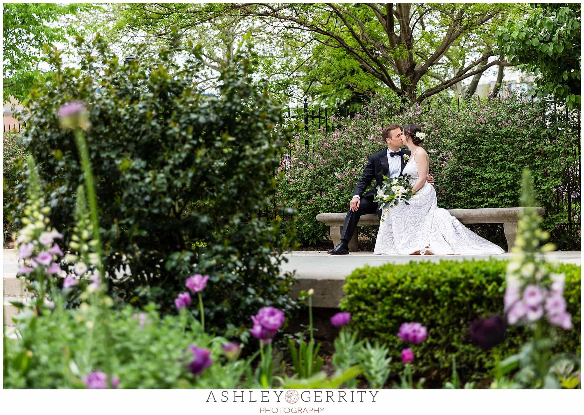 Bride and groom portraits, bride and groom kissing, shot through flowers, Free Library wedding