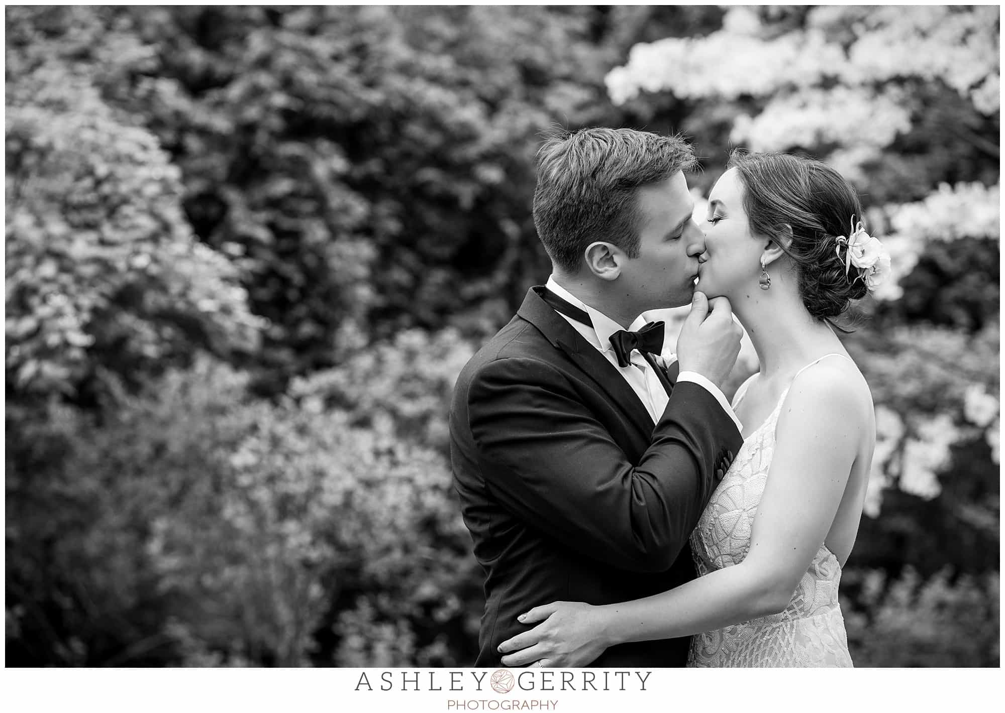 Black and white bride and groom portrait kissing