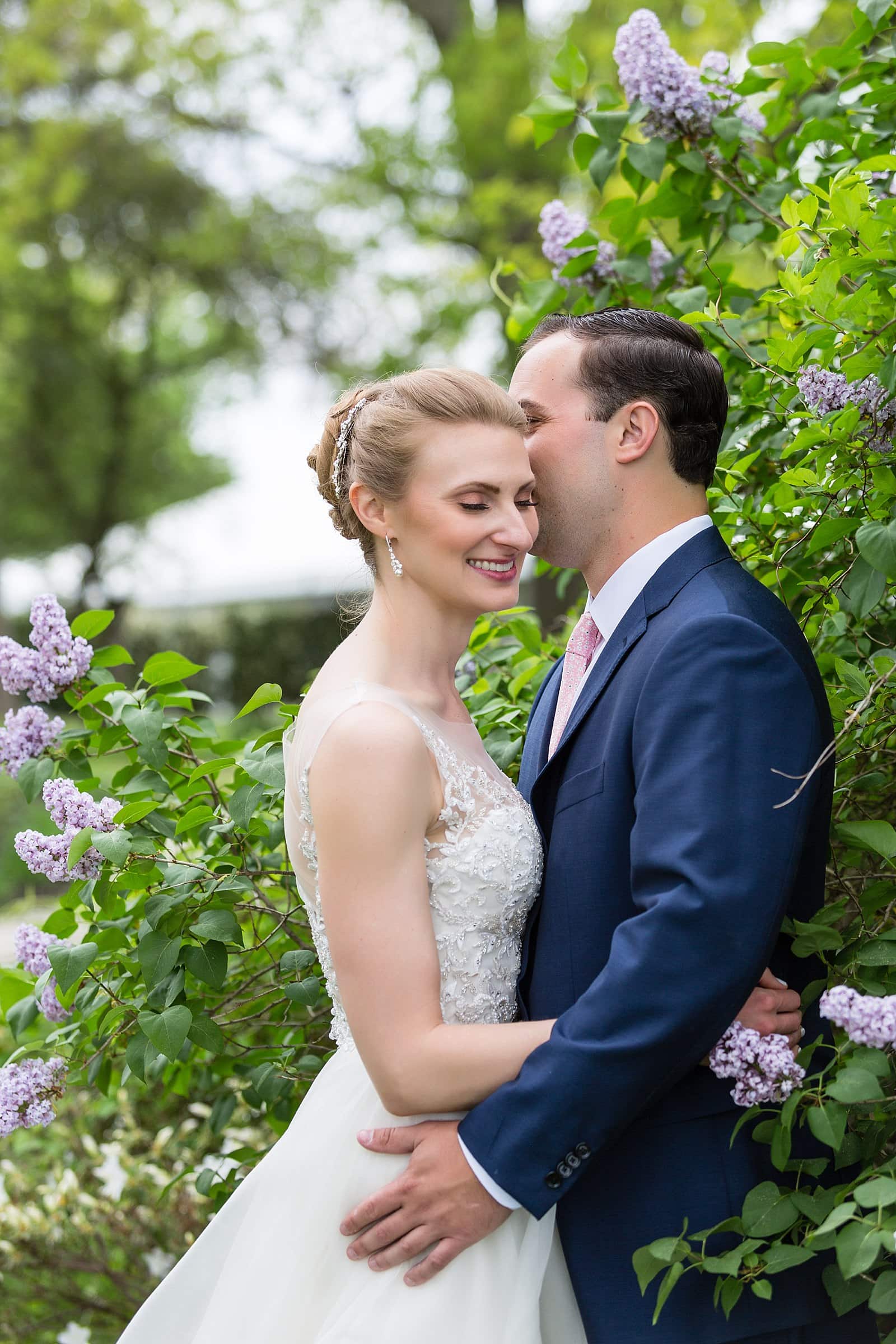 groom whispering to bride in the flowers, Glen Foerd Mansion wedding