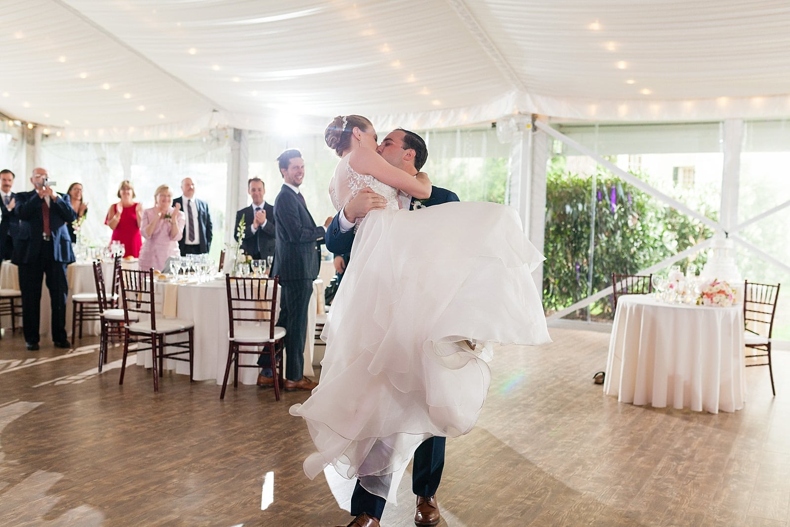 Bride and groom kissing on the dance floor, groom lifting bride and kissing, Glen Foerd Mansion wedding 